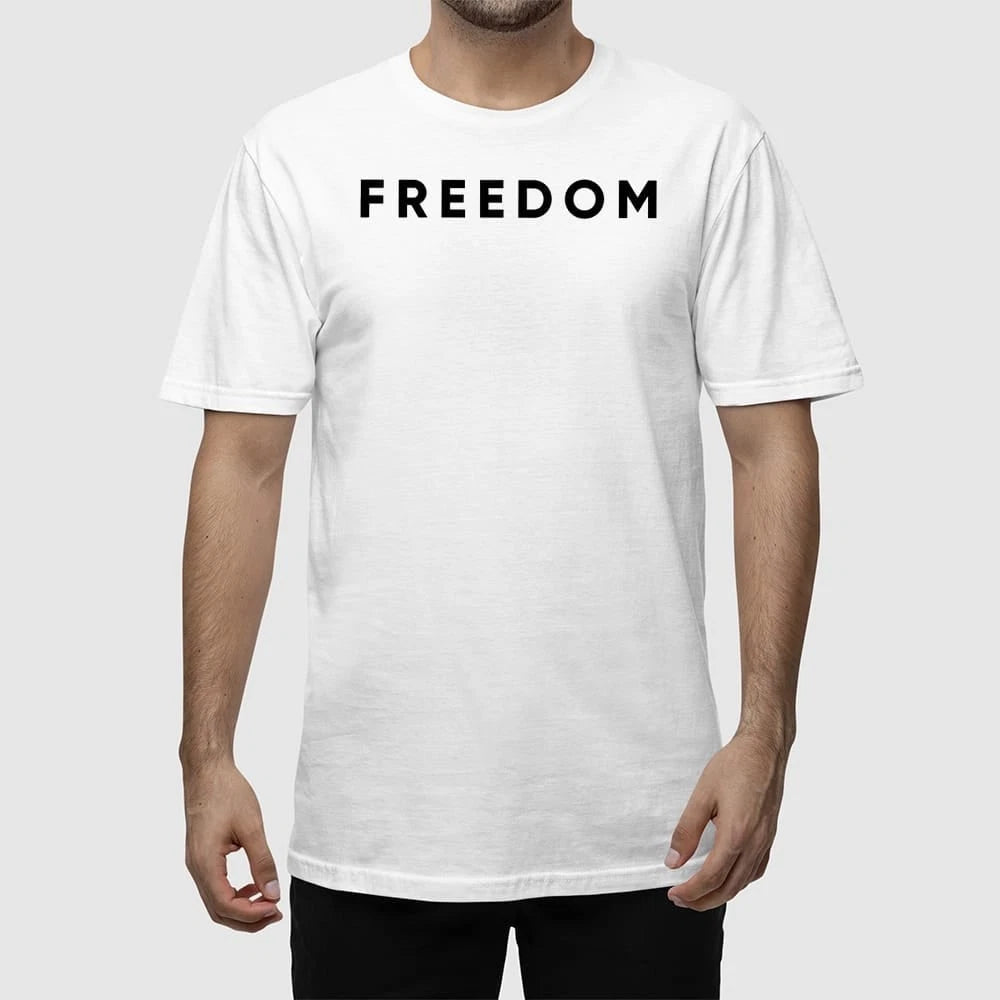 Man wearing the white Charlie Kirk Freedom T-Shirt at an outdoor conservative event.