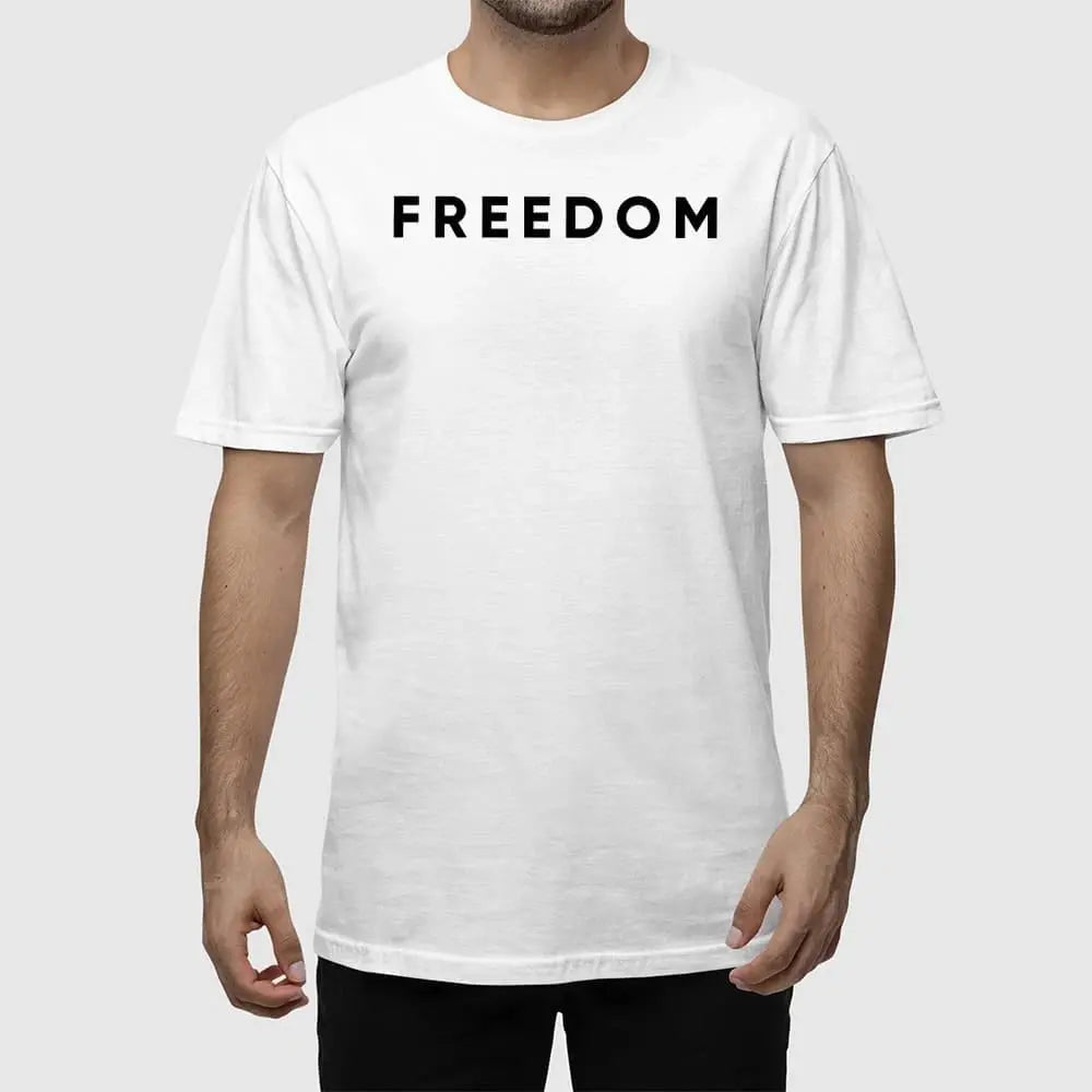 Man wearing the white Charlie Kirk Freedom T-Shirt at an outdoor conservative event.